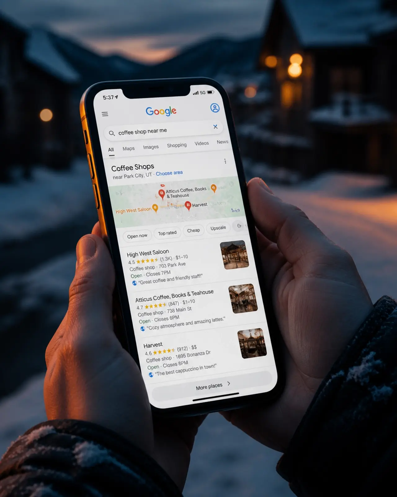 A person searching for HVAC services on a phone in a cold, snowy setting